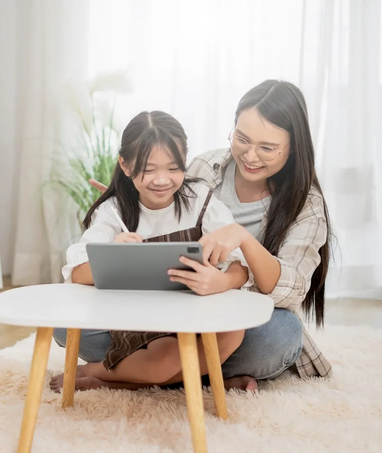A parent and child learning together with a tablet